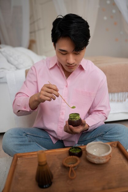 Full shot man with matcha tea