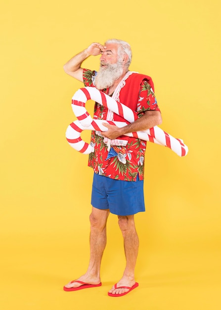 Full shot of man with tropical shirt and christmas hat