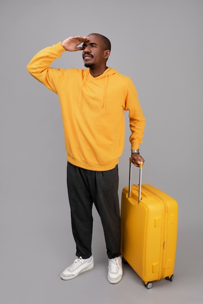 Full shot man with yellow baggage