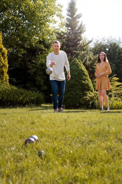 Full shot man and woman playing game