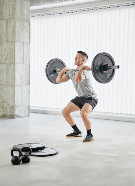 Full shot man working out with weights