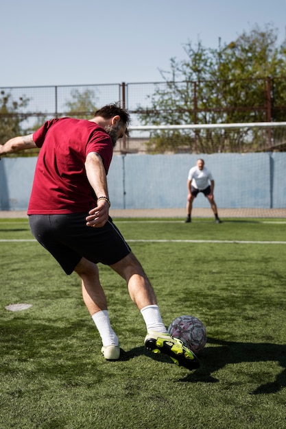 Full shot men playing soccer