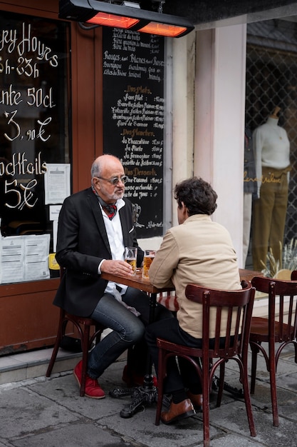 Free Photo full shot men sitting at table together