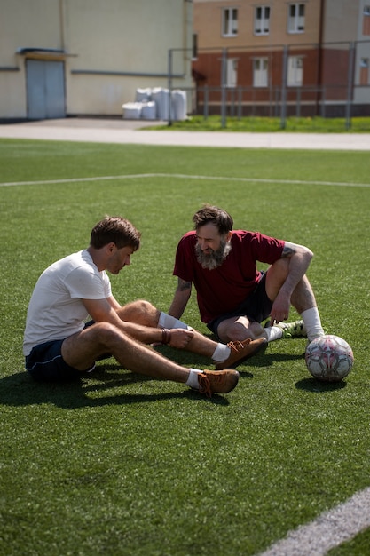 Free Photo full shot men on soccer field