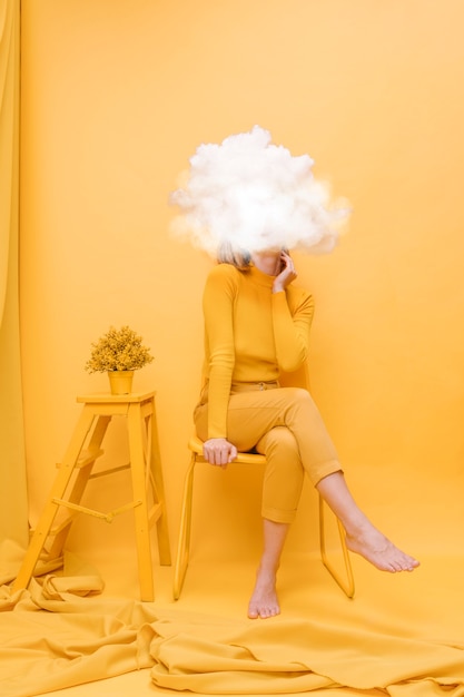 Free photo full shot model posing with cloud-shaped head