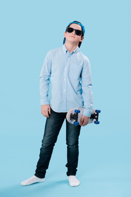 Full shot of modern boy with skateboard