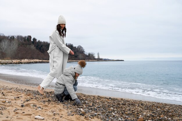 Full shot mother and kid at beach