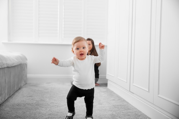 Full shot mother watching kid walk