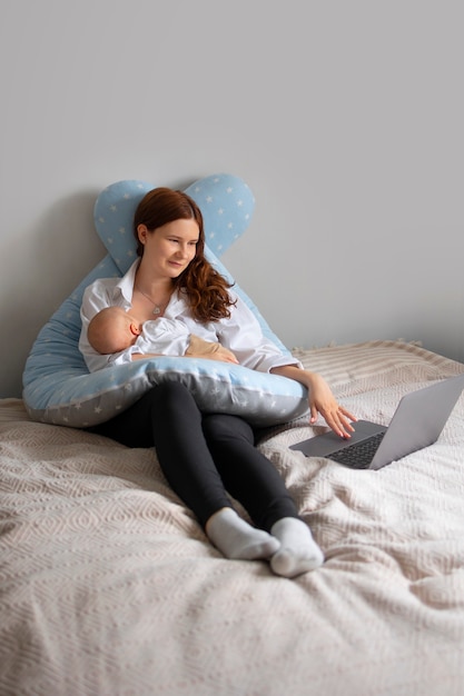 Full shot mother with baby at home