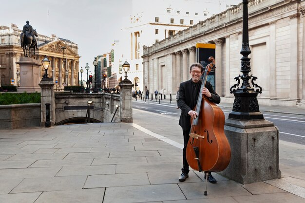 Full shot musician playing the double bass