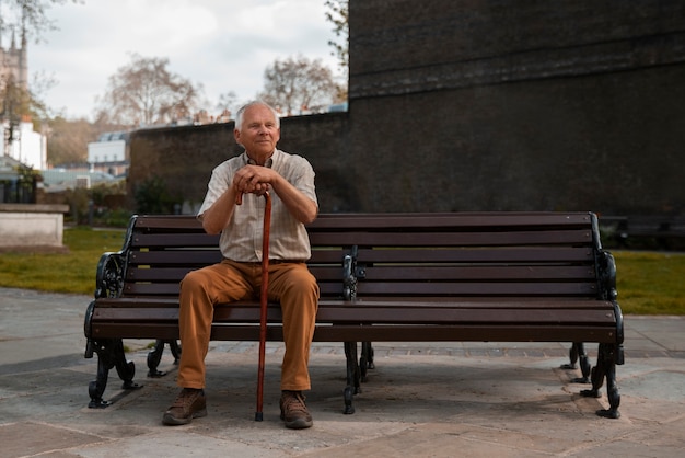 Free Photo full shot old man sitting on bench