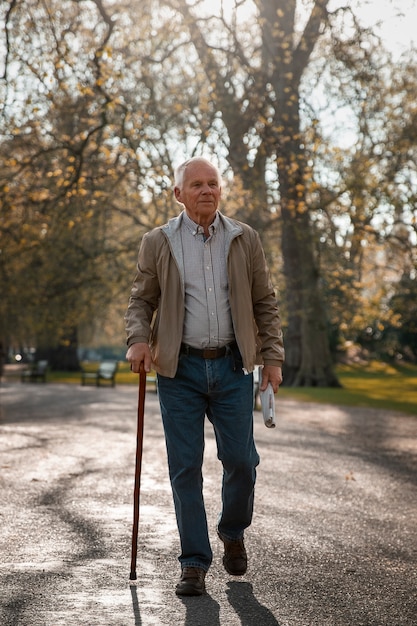 Free photo full shot old man taking a stroll