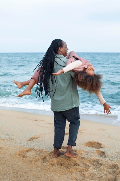 Full shot parent holding kid