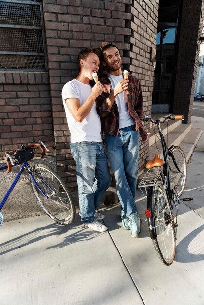 Full shot partners eating ice cream