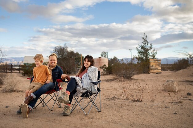 Full shot partners sitting on chairs outside