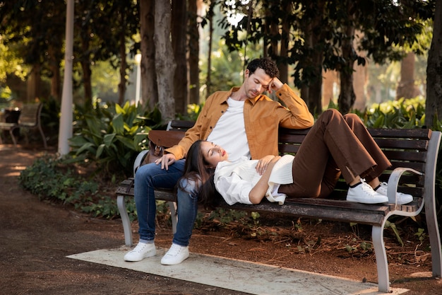 Full shot people on bench sleeping