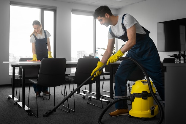 Full shot people cleaning office