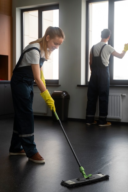 Full shot people cleaning office