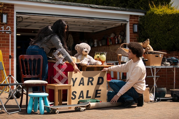 Full shot people at garage sale