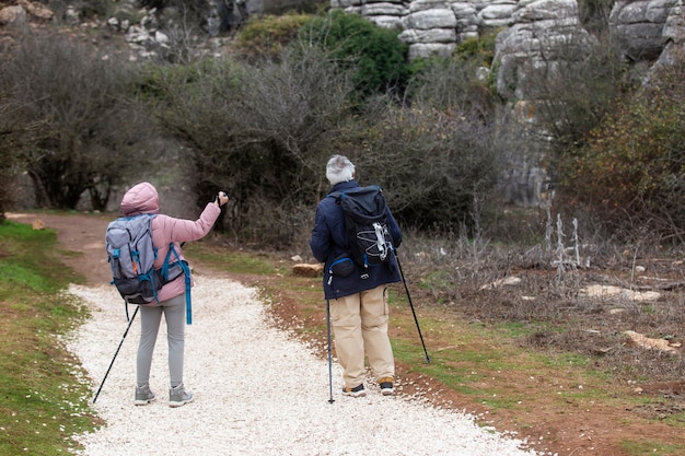 Full shot people hiking with backpacks