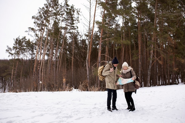 Full shot people in nature with map