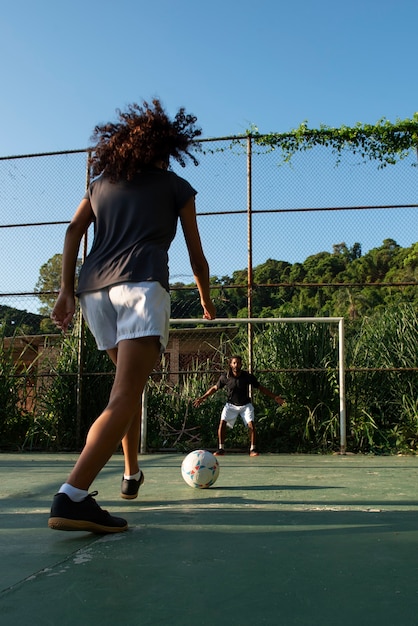 Full shot people playing soccer