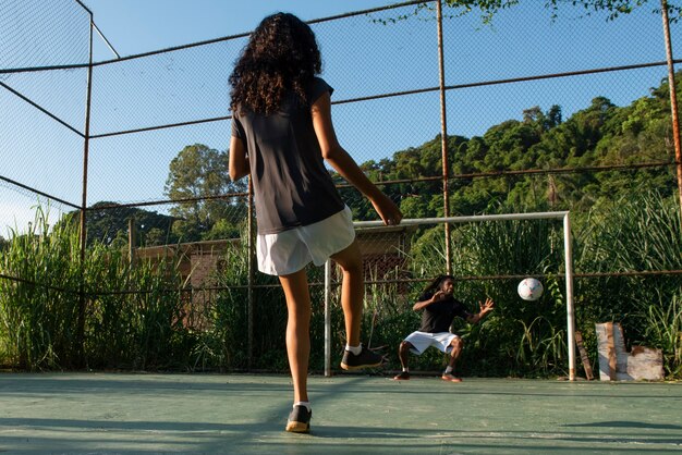 Full shot people playing soccer