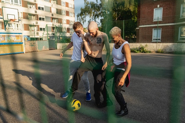 Free photo full shot people playing with ball