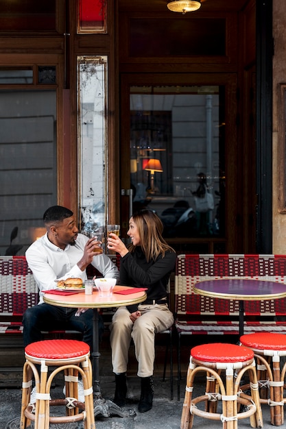 Free Photo full shot people relaxing at bistro outdoors