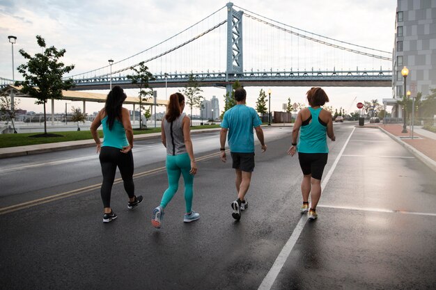 Full shot people running outdoors