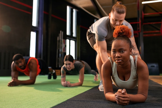 Full shot people training together at gym