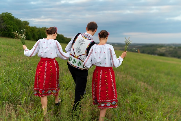 Free photo full shot people wearing traditional clothes