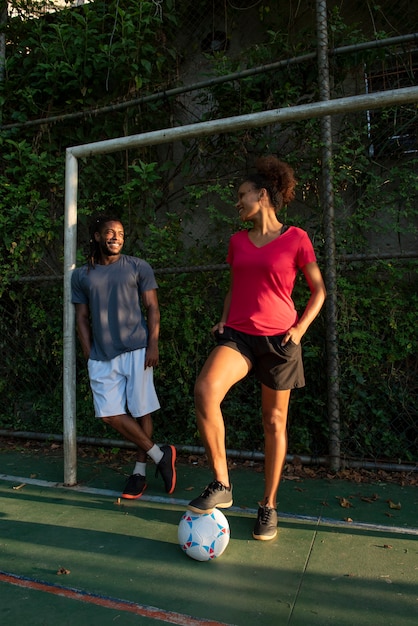 Free photo full shot people with soccer ball