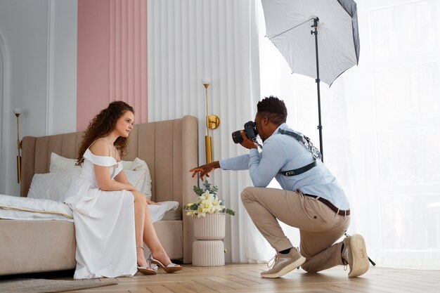 Full shot photographer taking photos of bride