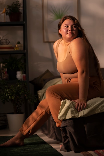 Full shot plus-sized woman in homewear