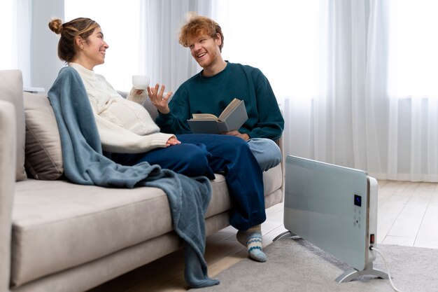 Full shot pregnant woman and man on couch