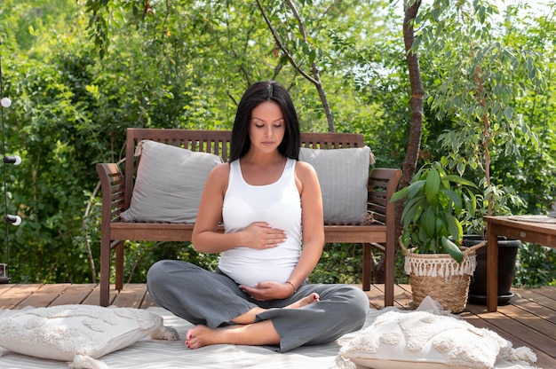 Full shot pregnant woman outdoors