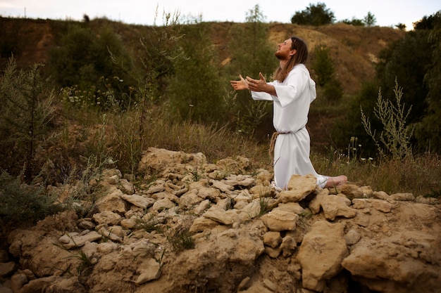 Free photo full shot prophet praying outdoors