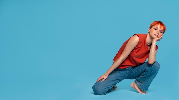 Free photo full shot queer woman posing in studio