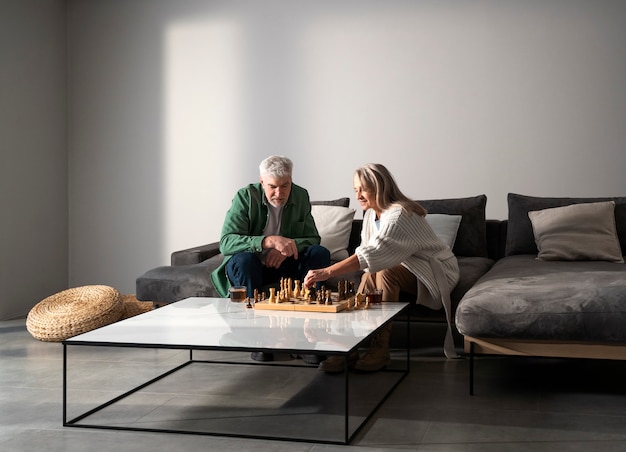 Full shot senior couple playing chess