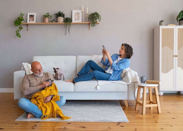 Full shot senior couple with cat at home