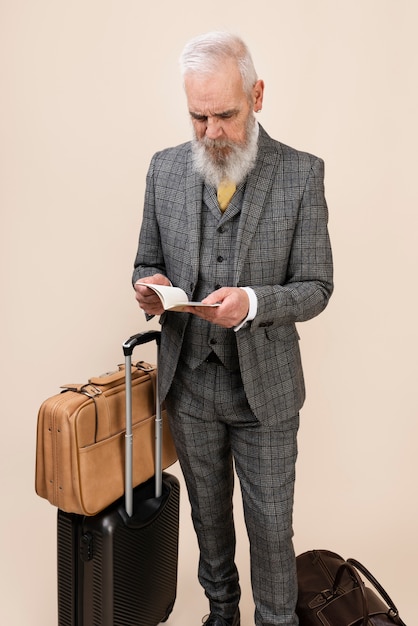 Full shot senior man holding passport