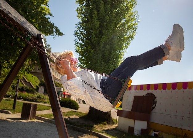 Free Photo full shot senior woman on swing