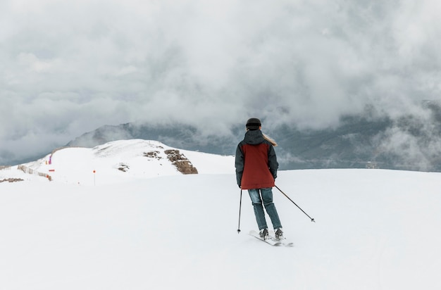 Full shot skier wearing helmet