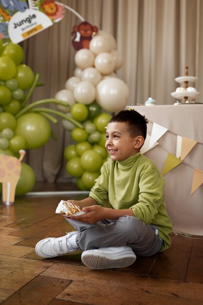 Full shot smiley boy with cake