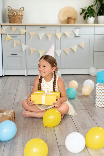 Full shot smiley girl holding present