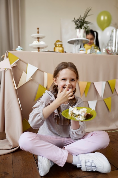 Full shot smiley girl with cake