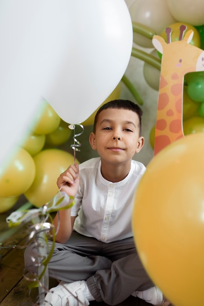 Free Photo full shot smiley kid with balloons