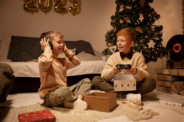 Full shot smiley kids with presents