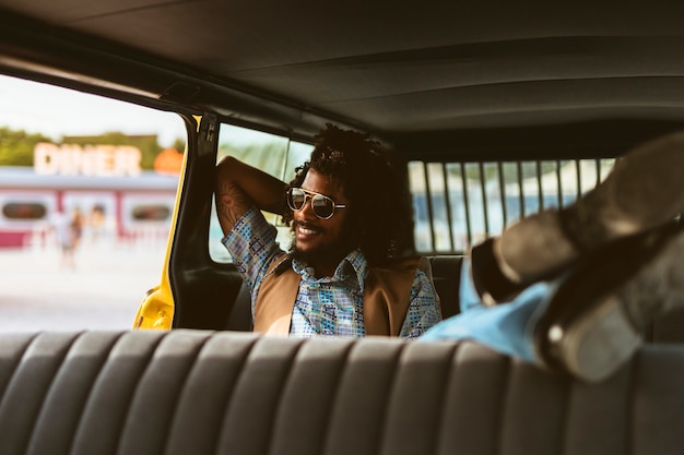 Full shot smiley man in car